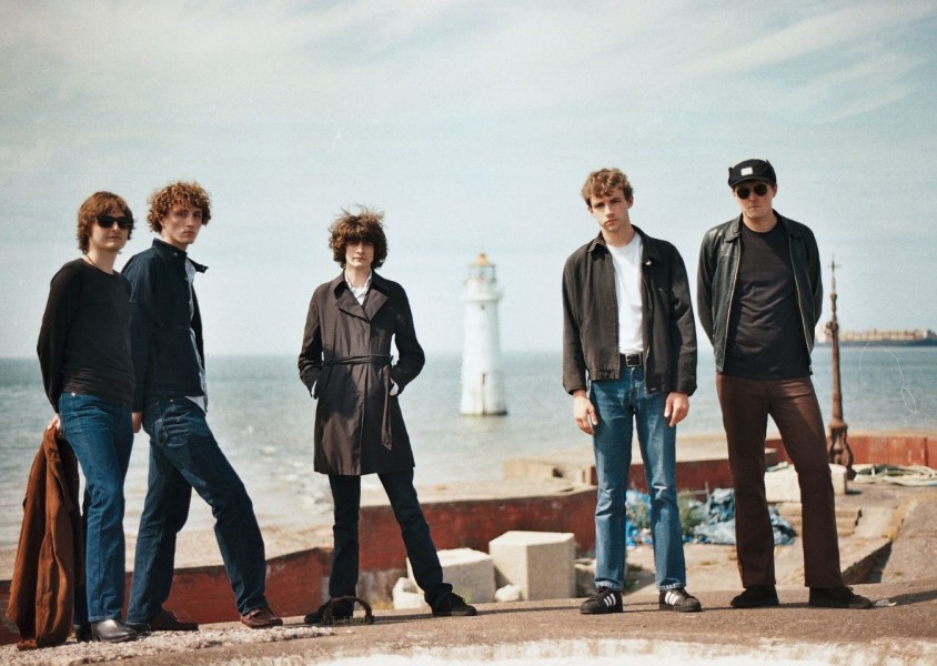 Five men stood on a pierx